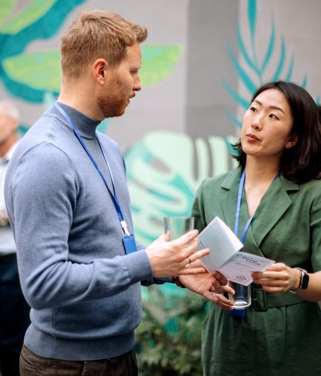 Colleagues having a casual conversation while attending conference